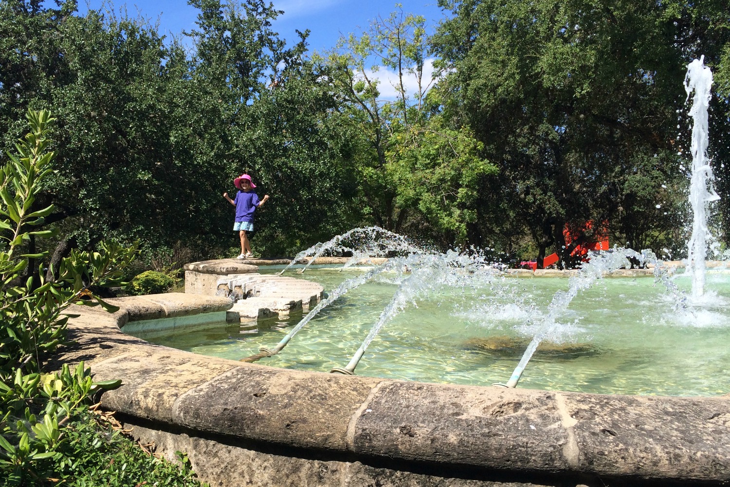 Playing at the fountain on the grounds of the McNay Art Museum | San Antonio Charter Moms