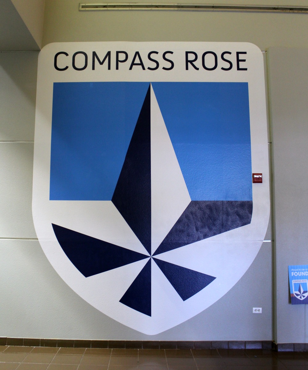 Compass Rose Academy shield logo decal in the school hallway | San Antonio Charter Moms