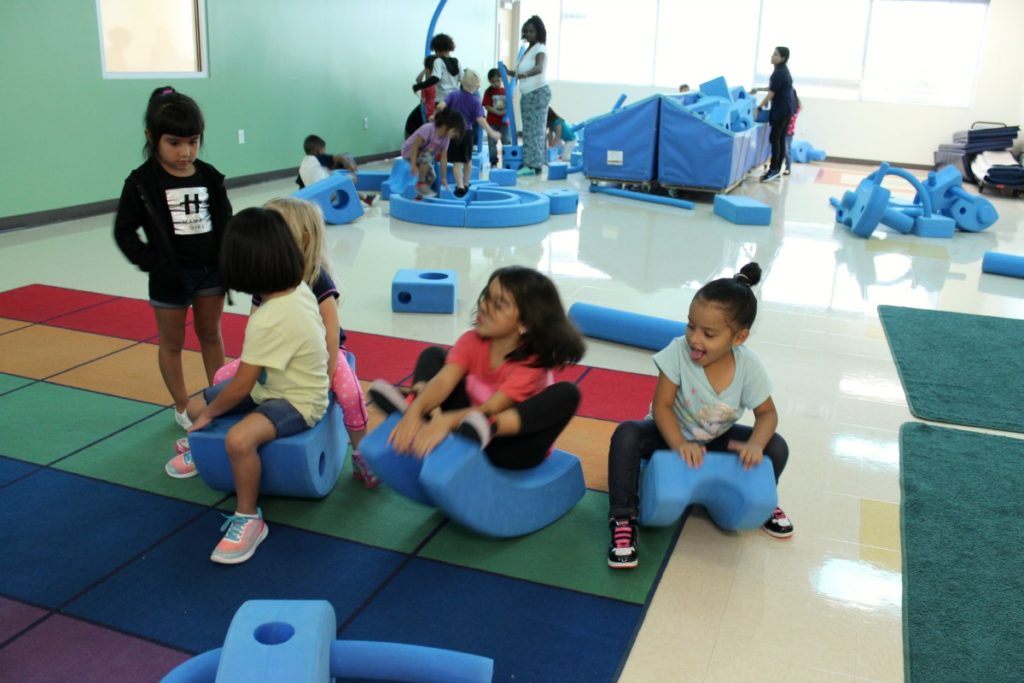 Gross motor skills with Imagination Playground big blue blocks in Motor Lab 1 at Pre K 4 SA South Education Center | San Antonio Charter Moms