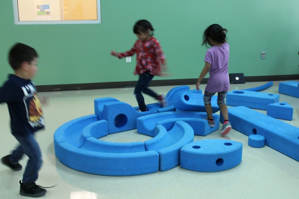 Gross motor skills with Imagination Playground big blue blocks in Motor Lab 1 at Pre K 4 SA South Education Center | San Antonio Charter Moms