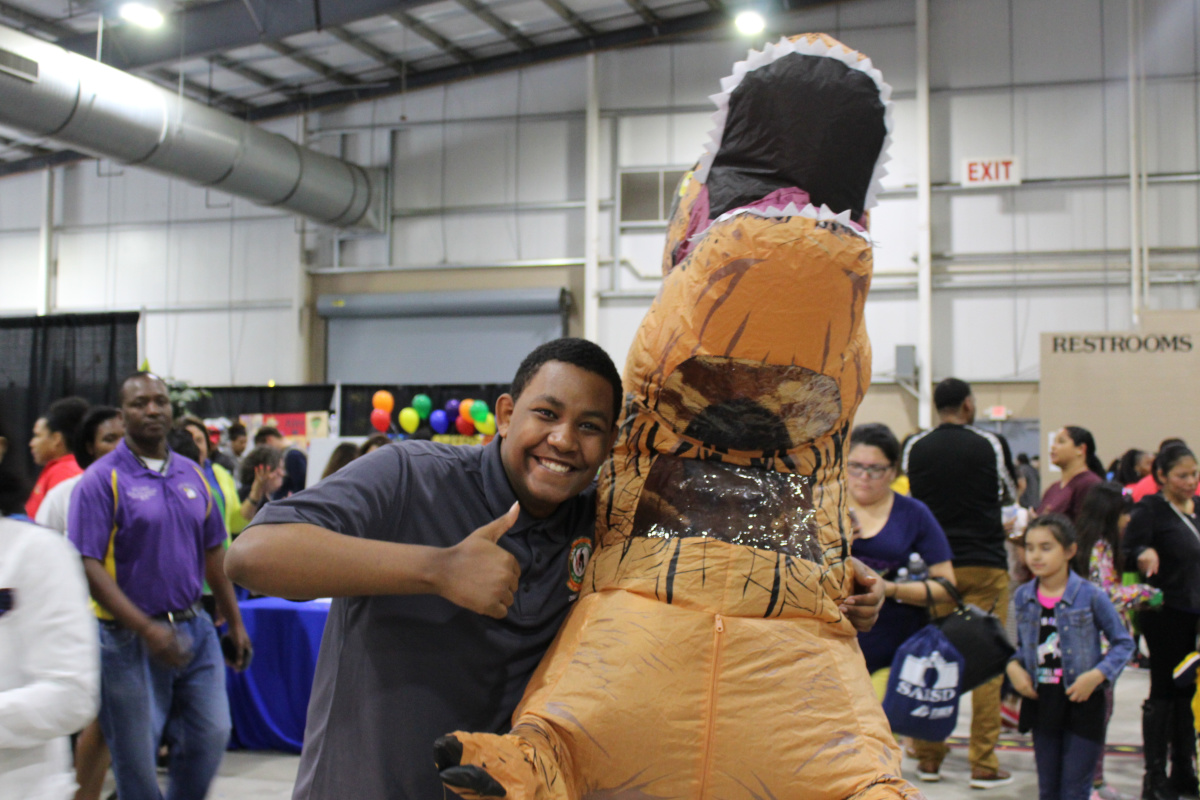 Dinosaur and friend at Experience SAISD | San Antonio Charter Moms