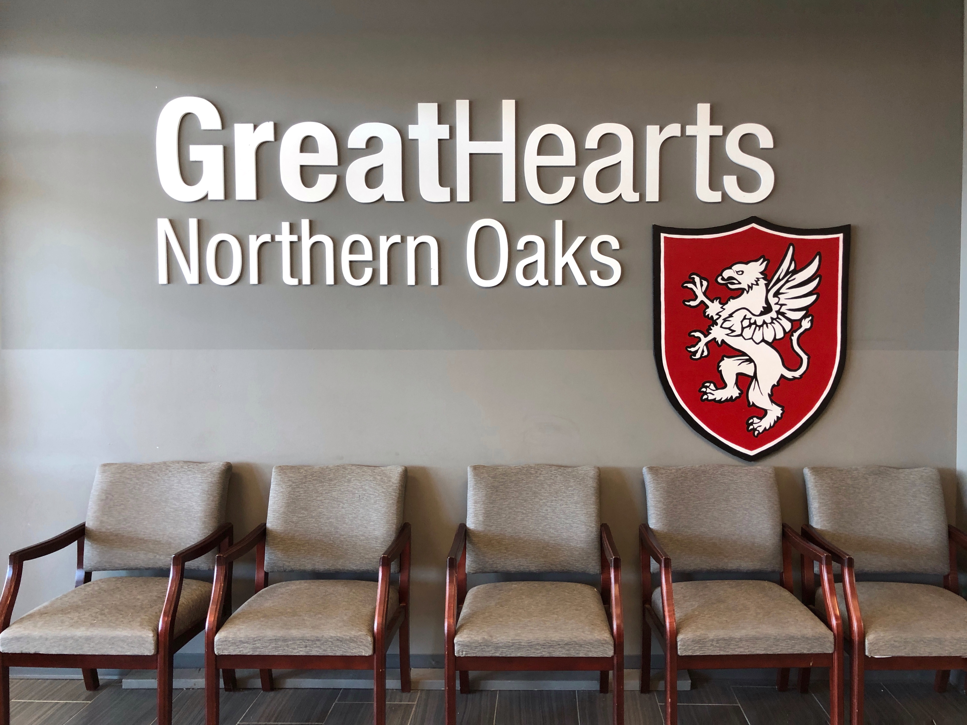 great hearts northern oaks logo above school chairs