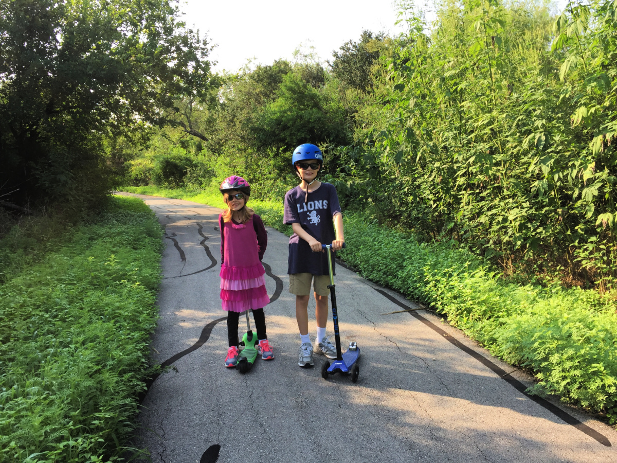 kids on scooters at the Salado Creek greenway trails