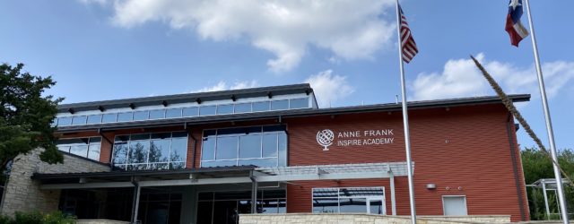 front of Anne Frank Inspire Academy school building with blue sky in background