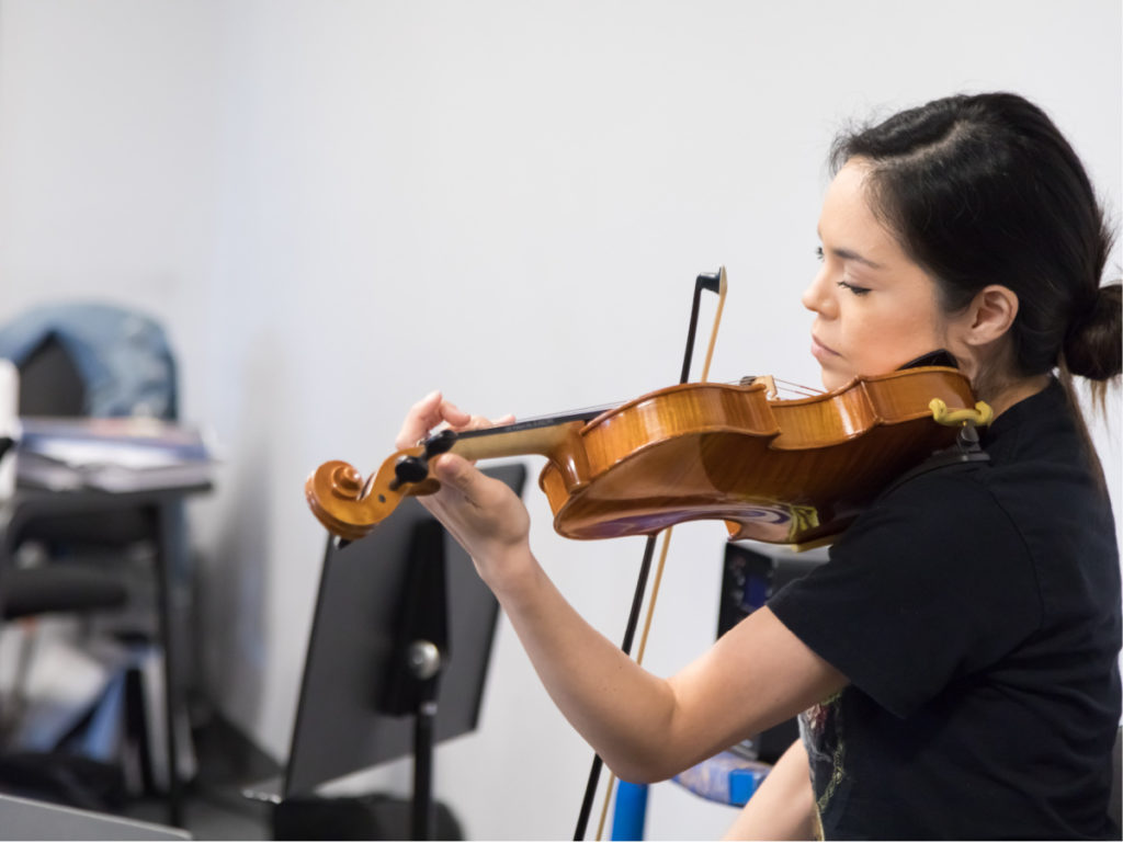 BASIS San Antonio Shavano fine arts student playing violin for orchestra