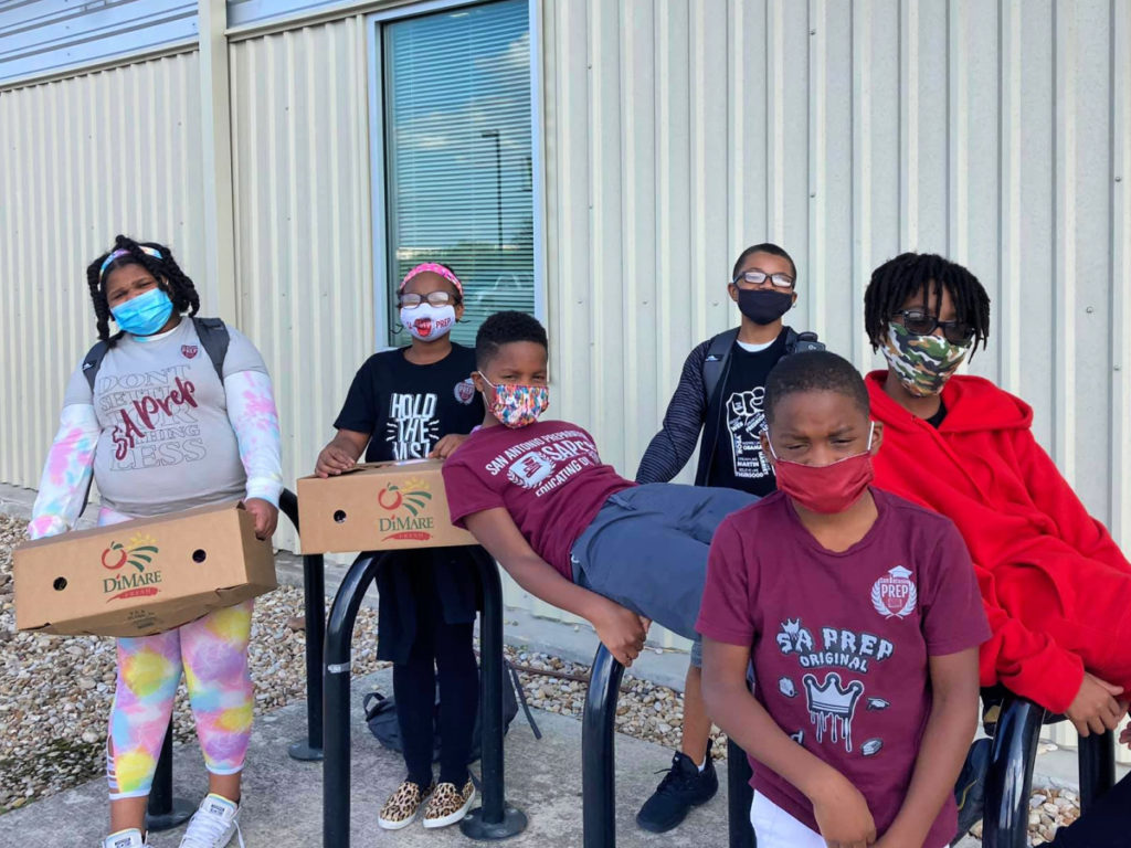 San Antonio Prepatory charter school students with meal boxes