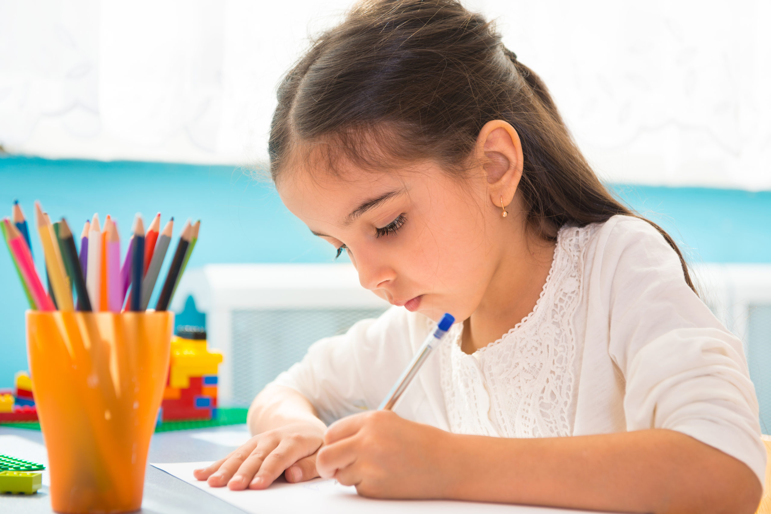 charter school kindergarten student focused on her writing