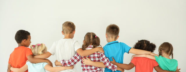 group of diverse kids facing away and wrapping arms around each other