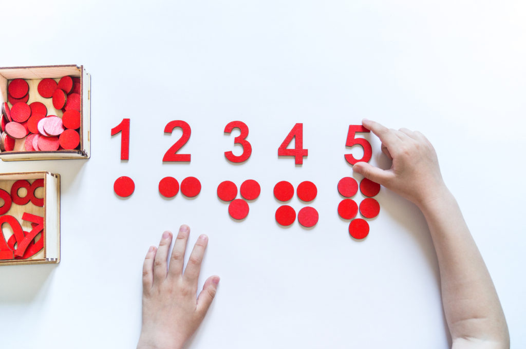 child's hands using red math manipulitives | learning style myth