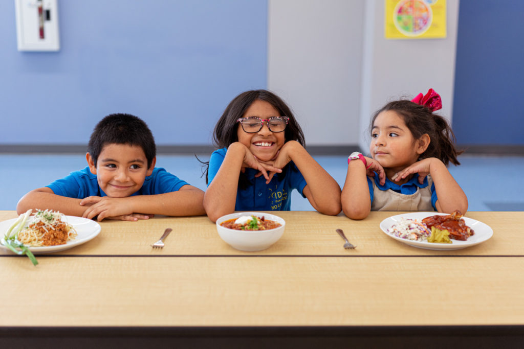 IDEA Public Schools Child Nutrition Program Cookbook three students 