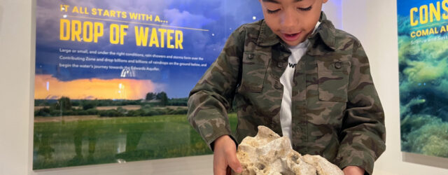 Visitor with limestone rock Edwards Aquifer Authority Education Outreach Center EAAEOC